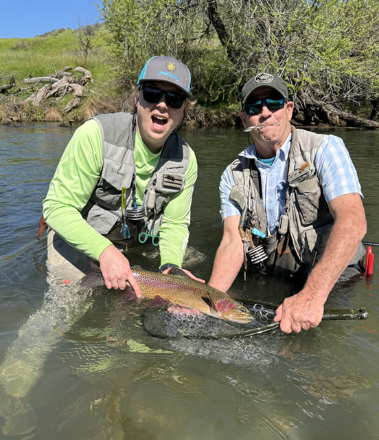 Client and Richard holding a rainbow trout